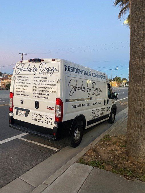 A white van is parked on the side of the road.