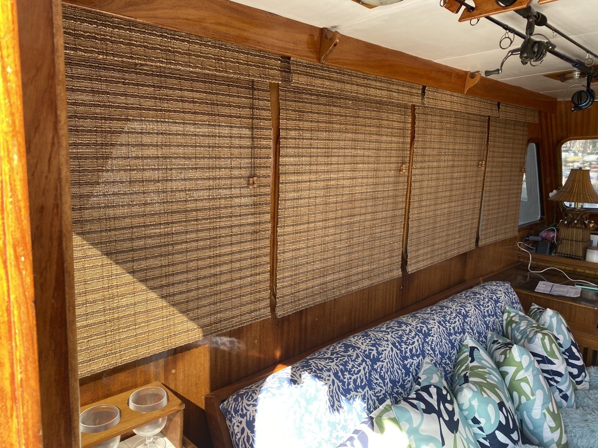 A living room on a boat with a couch and a ceiling fan.