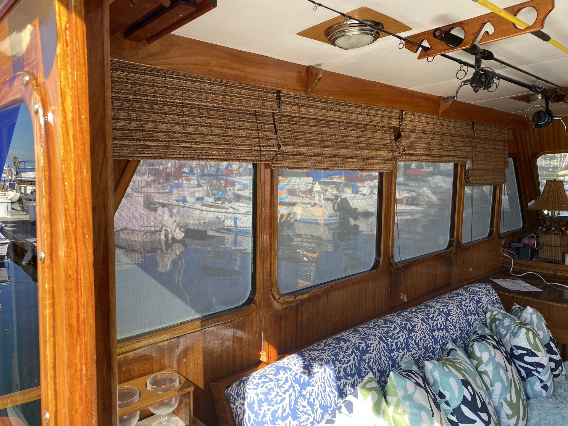 A living room on a boat with a couch and lots of windows