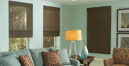 A living room with a couch , chair , table and lamps