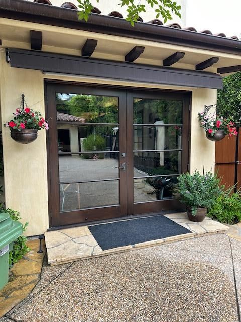 A house with a lot of windows and flowers on the wall