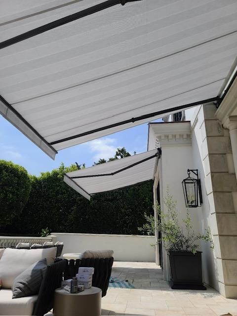 A patio with a white awning over it