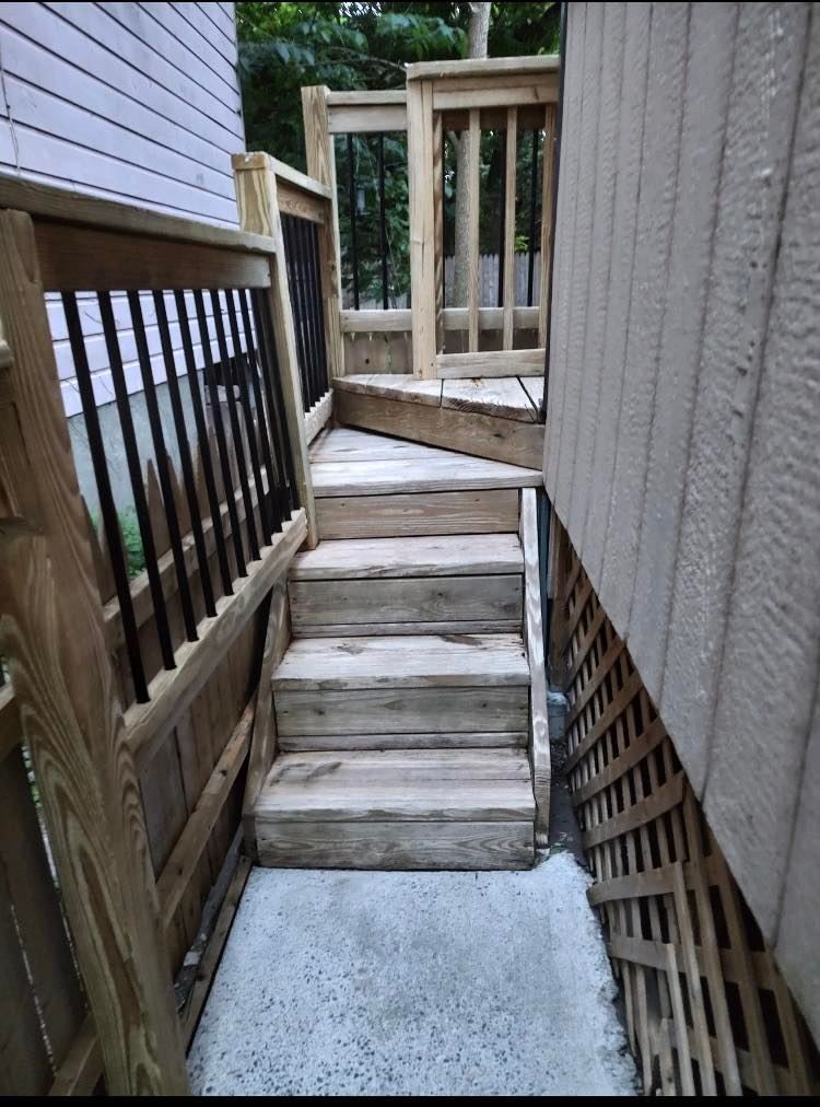 A wooden deck with stairs leading up to it