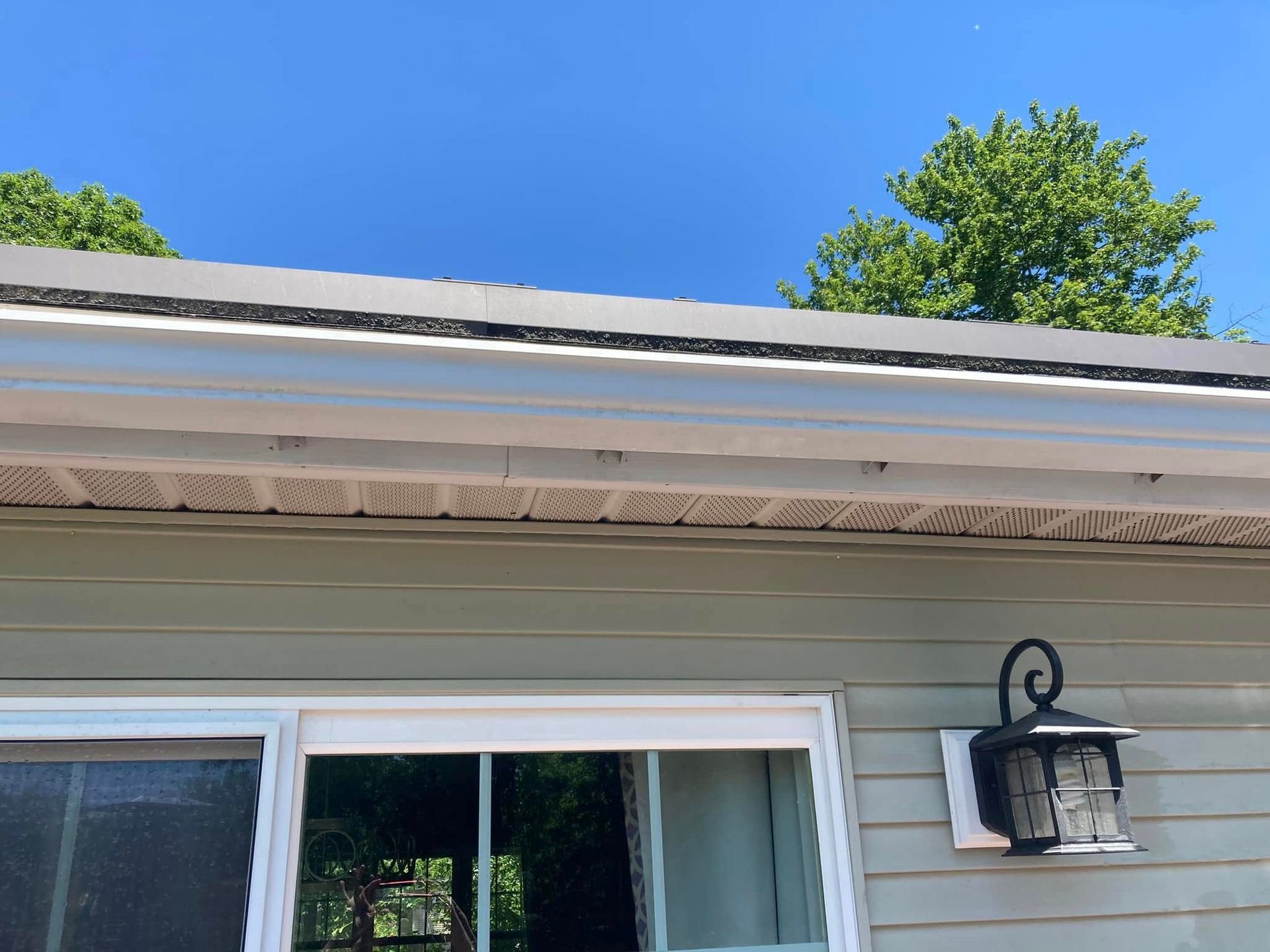 A house with a window and a light on the side of it.