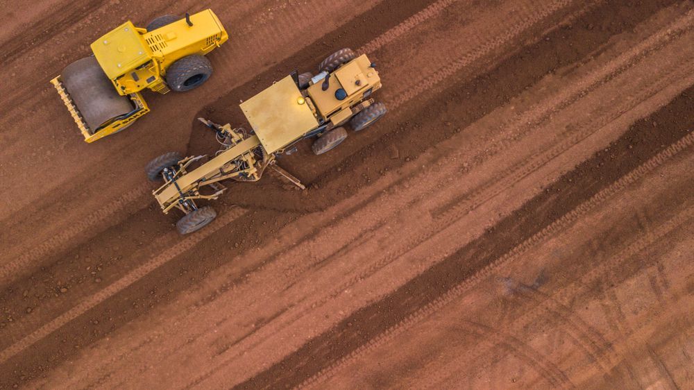 Yellow Construction Equipment Smoothing and Compacting Earth — Shantui QLD in Roma, QLD