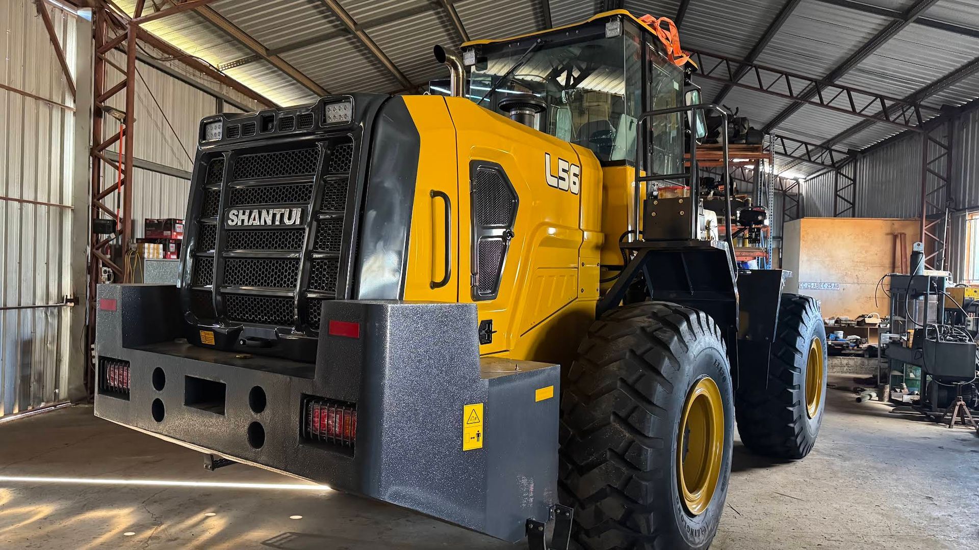 Yellow and Black Shantui L56 Wheel Loader Inside a Metal Building — Shantui QLD in Kingsthorpe, QLD