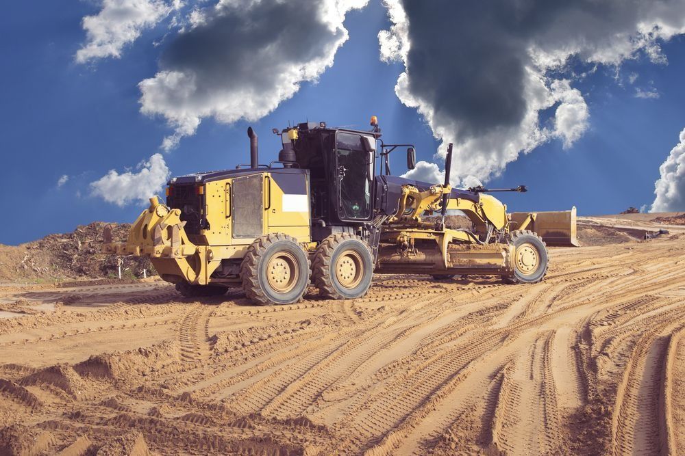 Yellow Grader on Sandy Ground Under a Cloudy Blue Sky — Shantui QLD in Goondiwindi, QLD