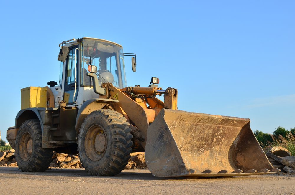 Yellow and beige wheel loader on a paved surface, bucket down, under a blue sky — Shantui QLD in Goondiwindi, QLD