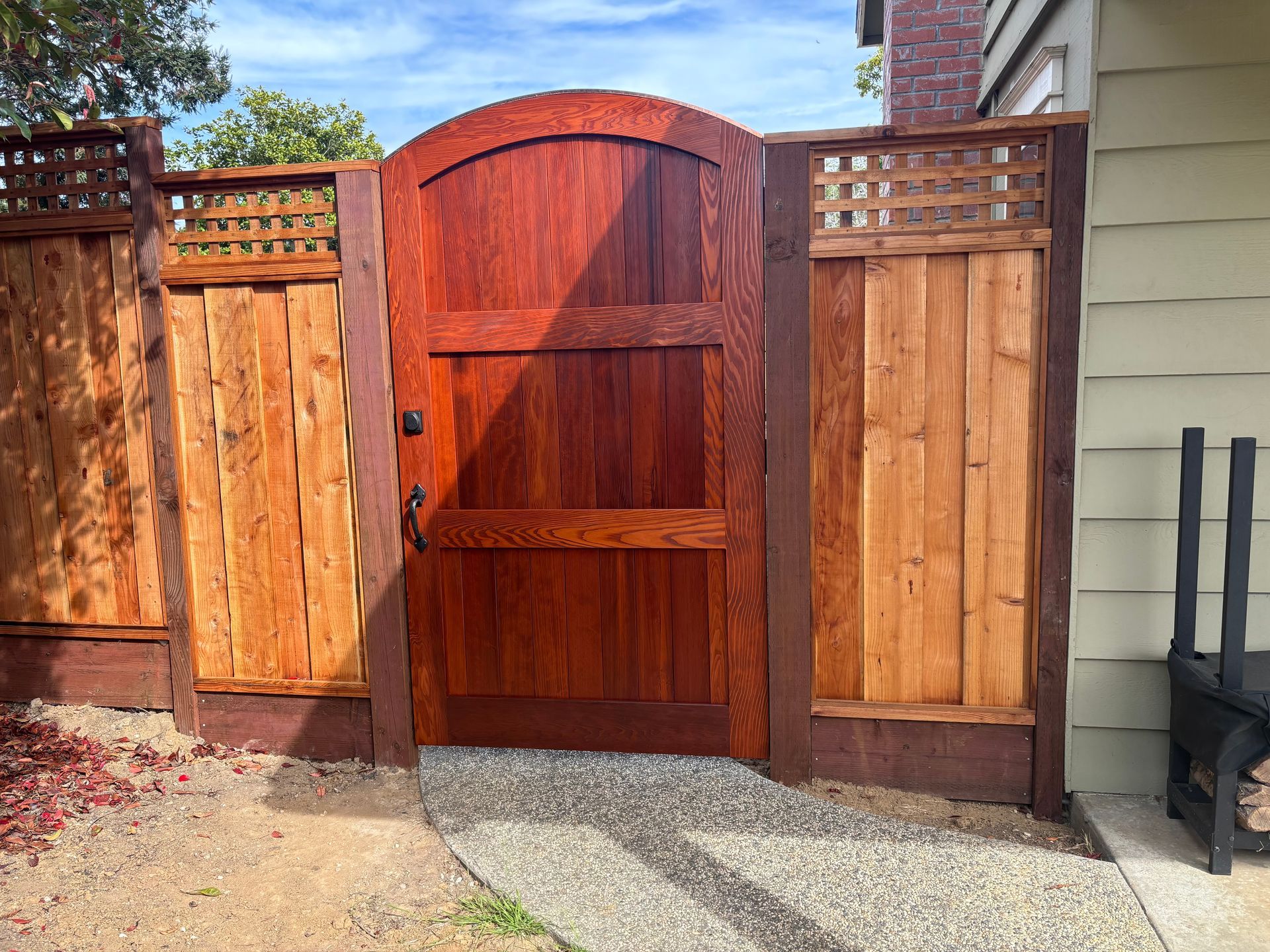 A wooden door is surrounded by a stone wall.