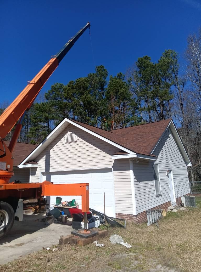 A crane is sitting in front of a house.