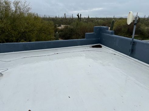 A white roof with a satellite dish on it