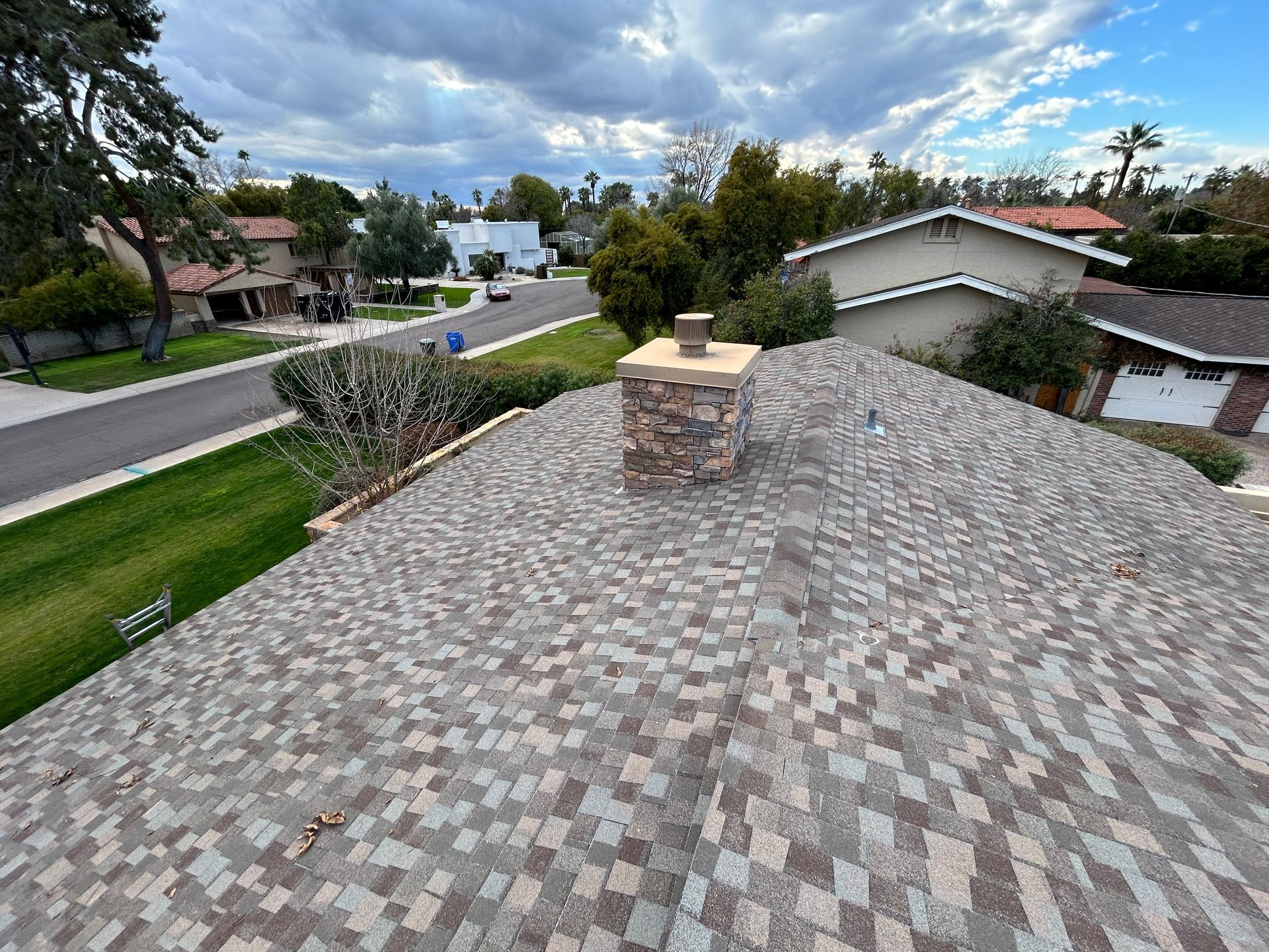 A roof with a chimney on it in a residential area