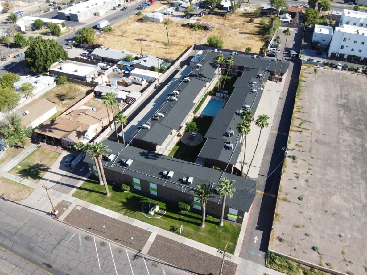 An aerial view of a large apartment complex with palm trees