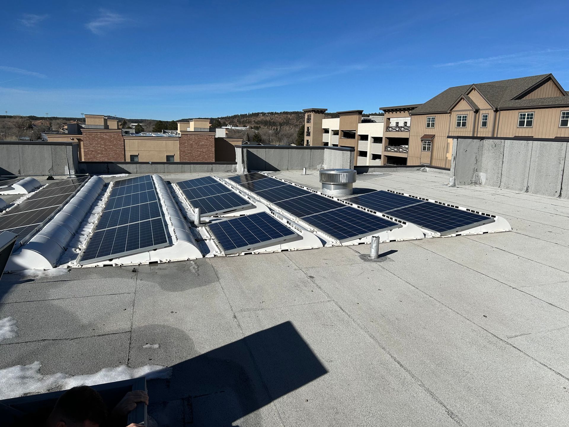 A row of solar panels on the roof of a building