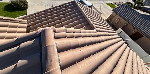 The roof of a house has a lot of tiles on it