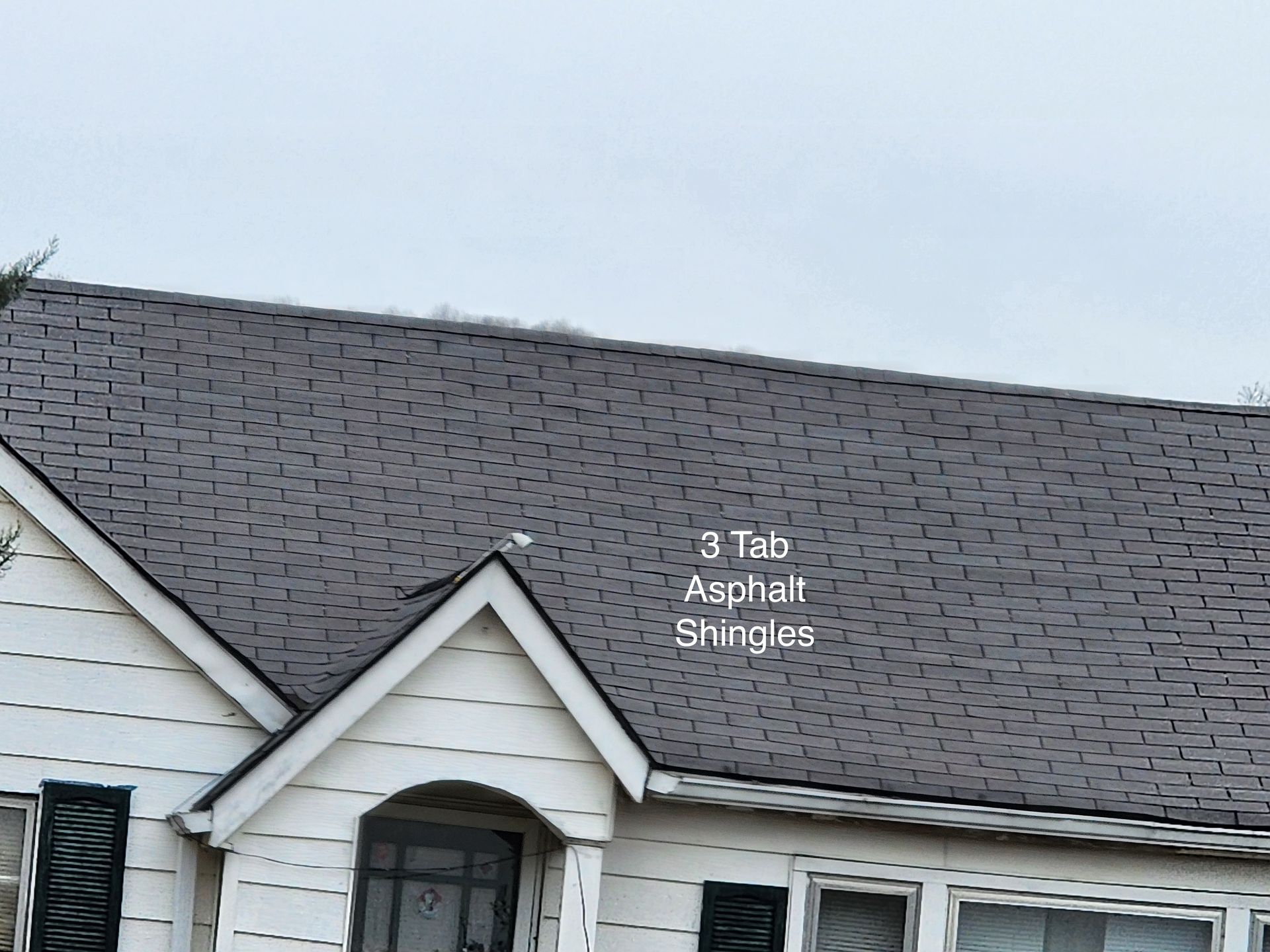 Brown asphalt shingle roof with a round metal vent.