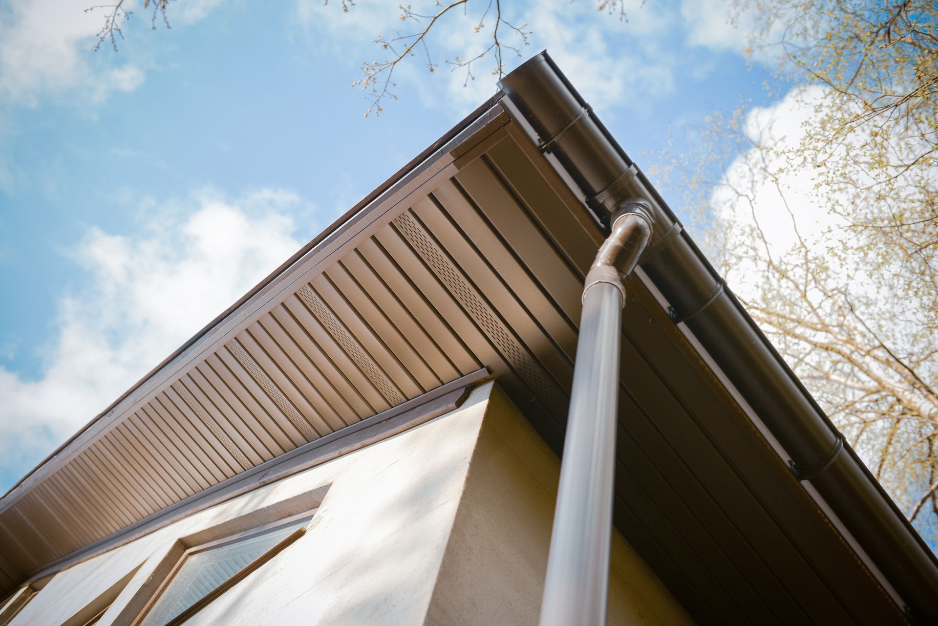 Looking up at the roof of a house with a gutter