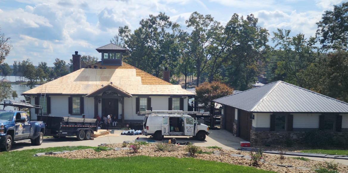 A large house with a metal roof is being built.