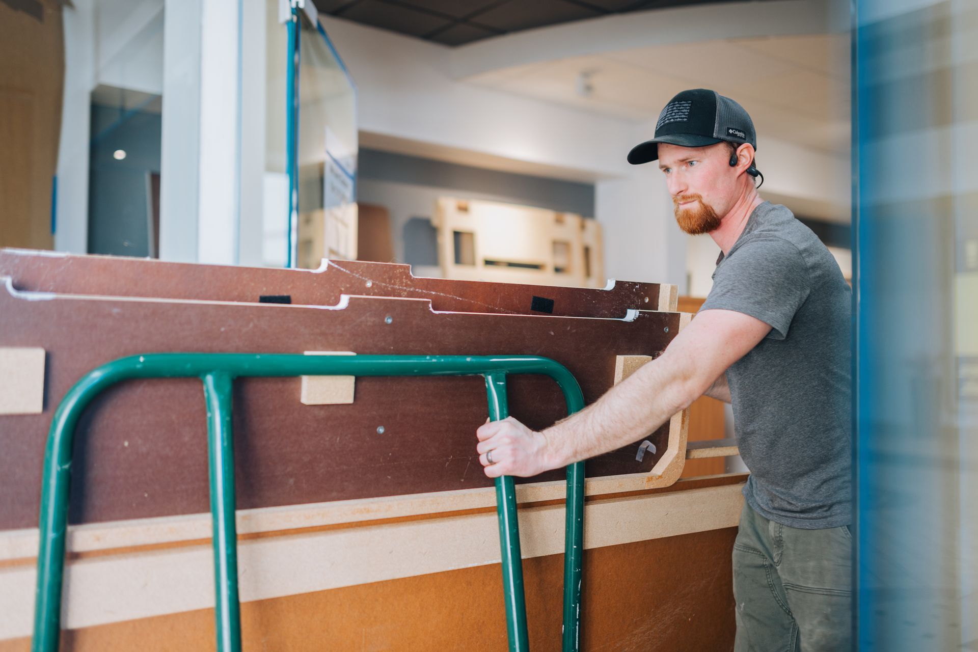 A man is pushing a cart with a table on it.