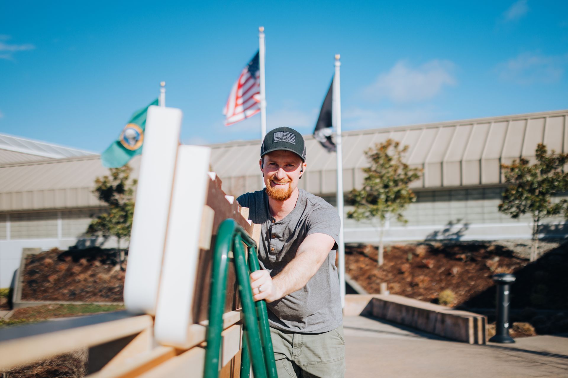 A man is standing in front of a building holding a rope.