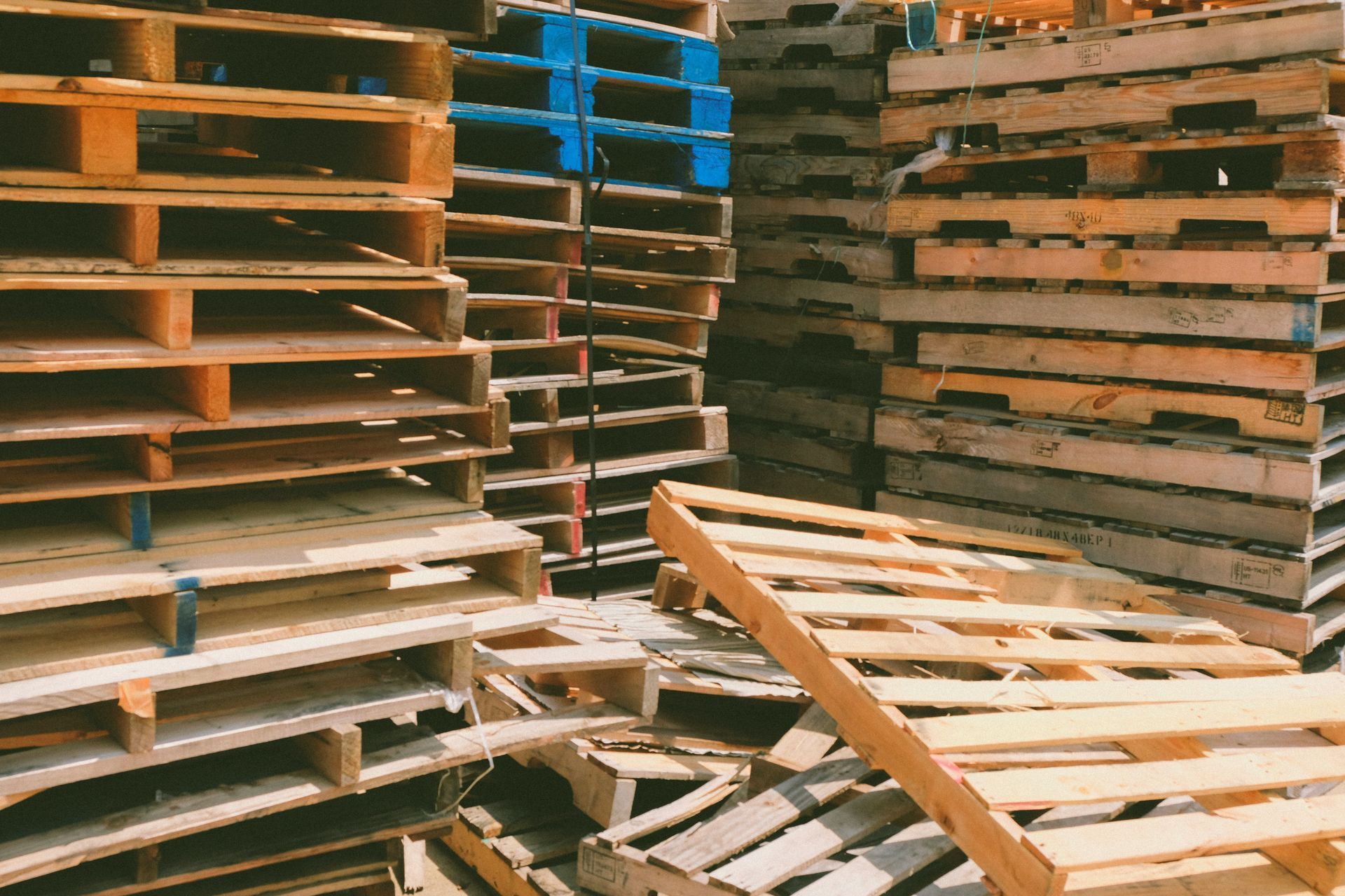 A pile of wooden pallets stacked on top of each other.