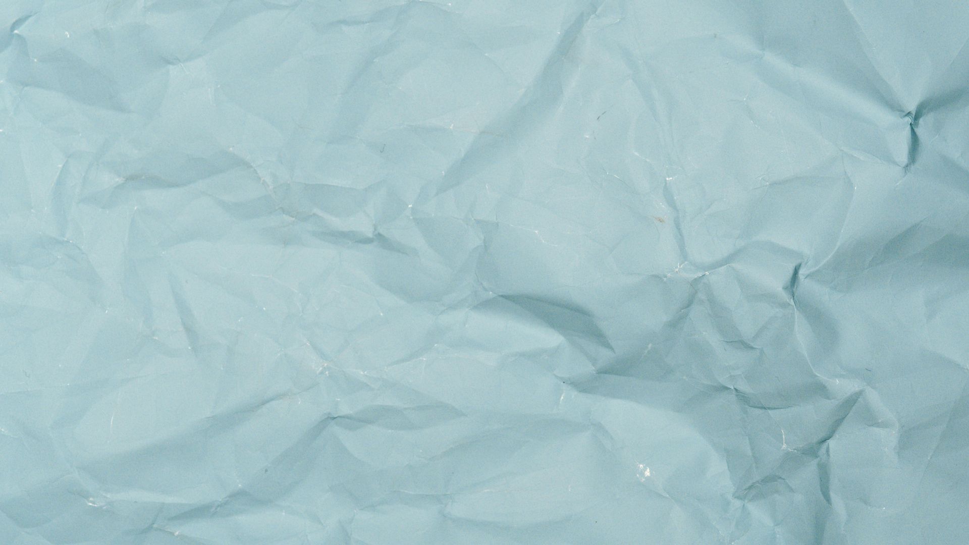 A close up of a piece of crumpled blue paper.