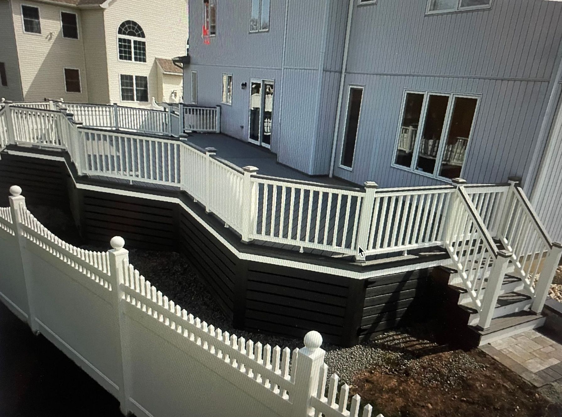 A picture of a deck with a white fence and stairs