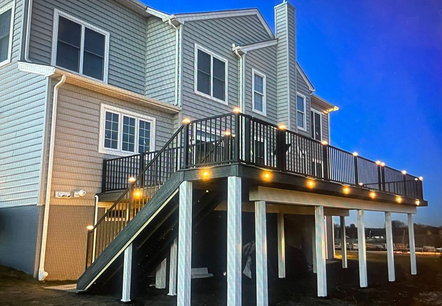 A large house with a large deck and stairs