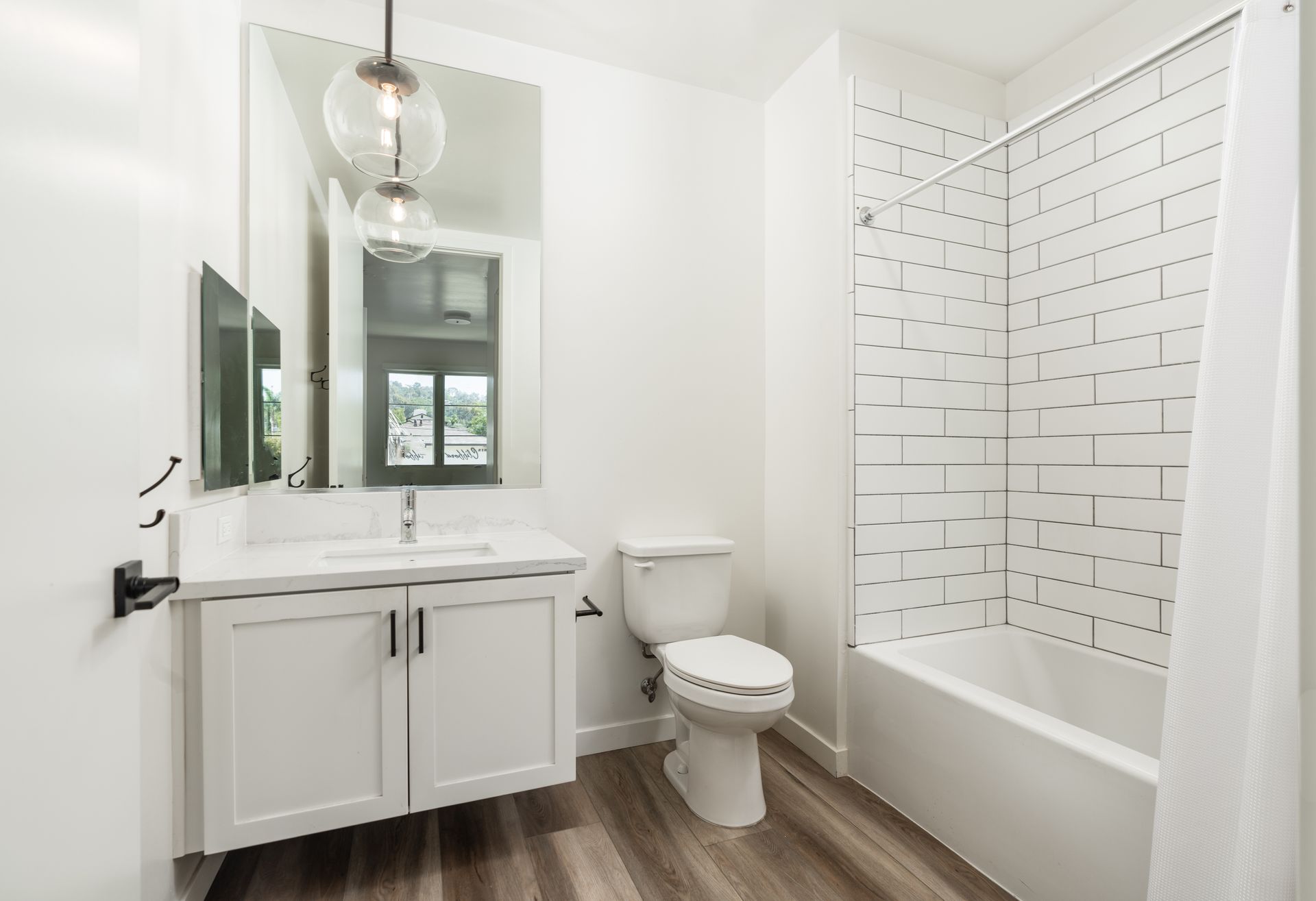 A bathroom with a toilet , sink , and bathtub.