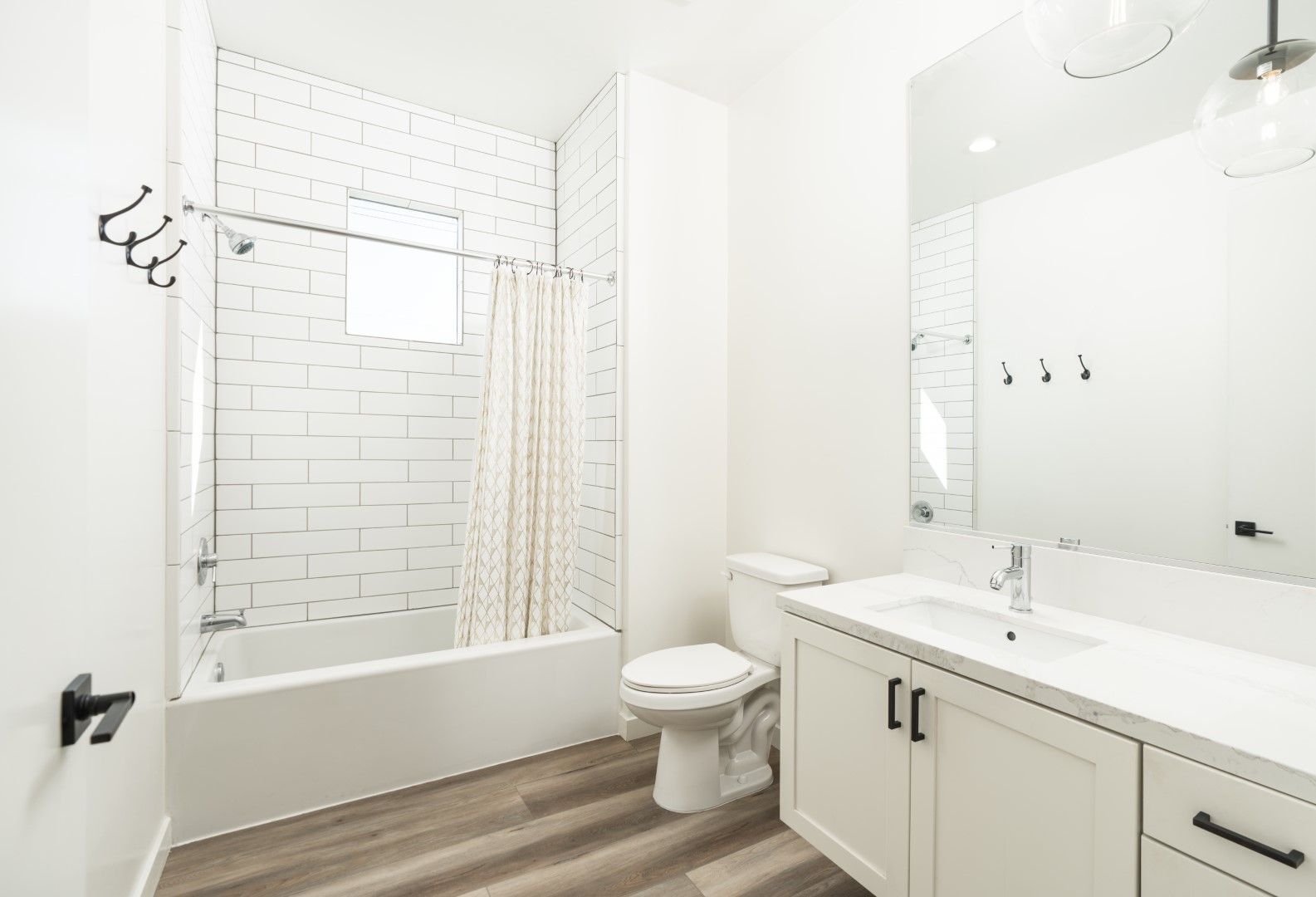 A bathroom with a toilet , sink , and bathtub.