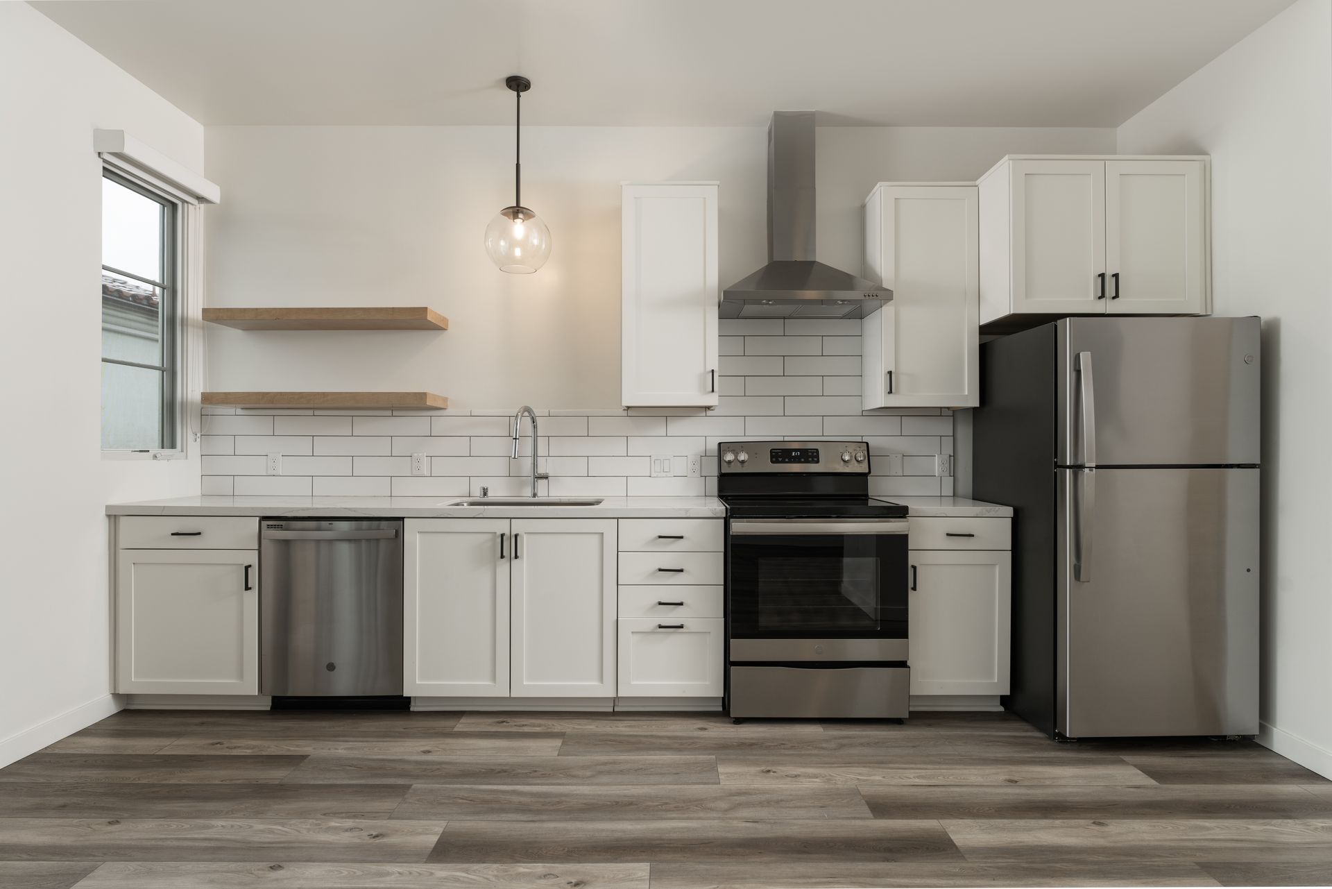 A kitchen with stainless steel appliances and white cabinets