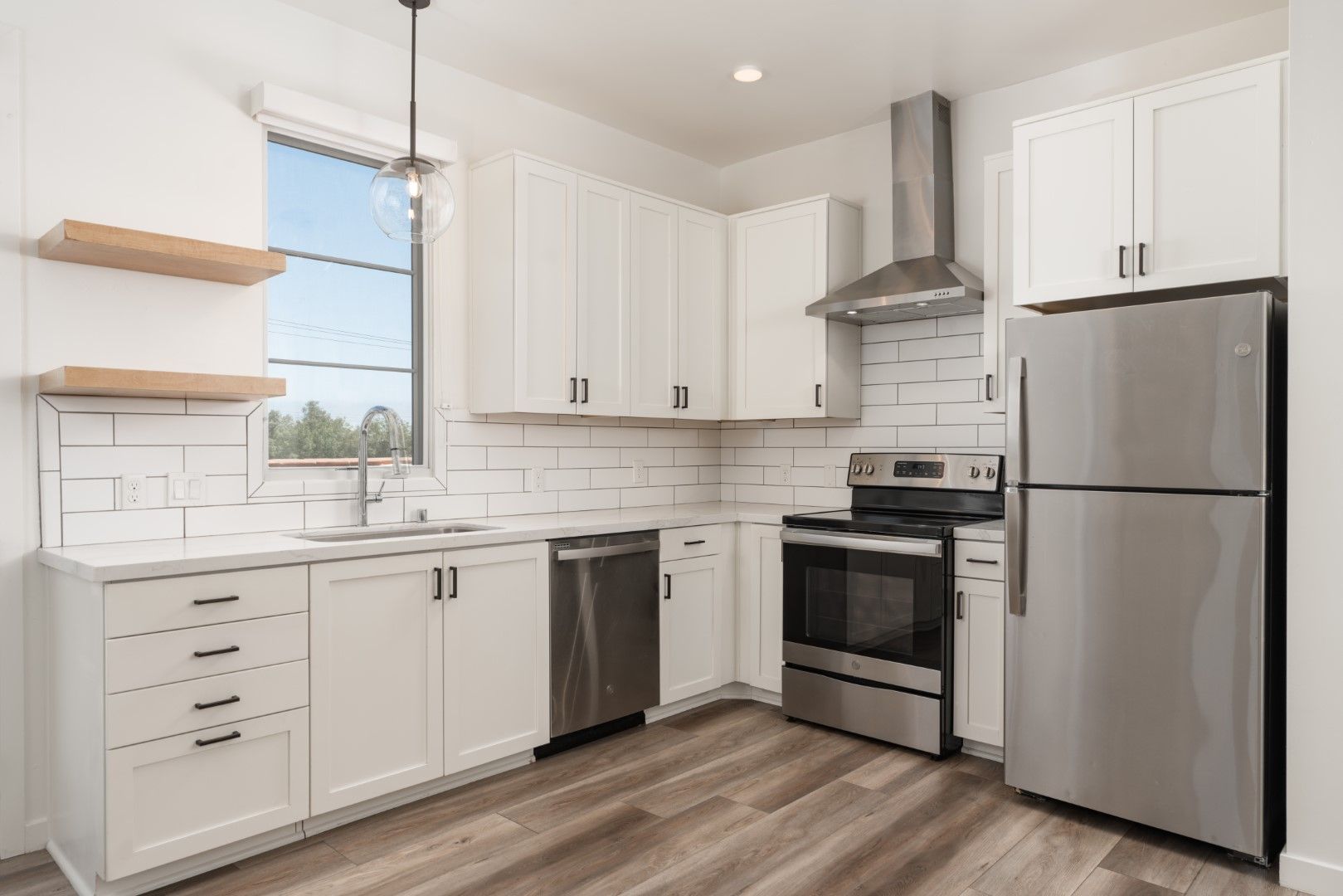 A kitchen with white cabinets and stainless steel appliances.