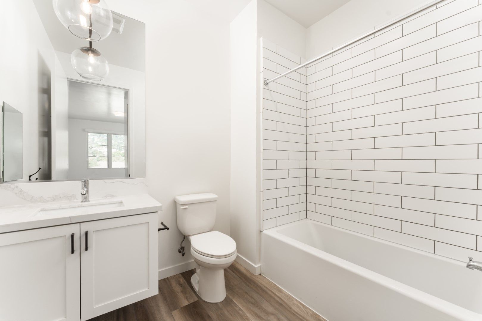 A bathroom with a toilet , sink , and bathtub.