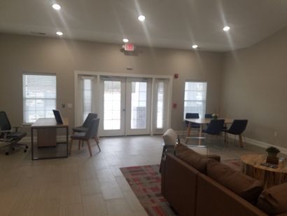 A living room with a couch a table and chairs