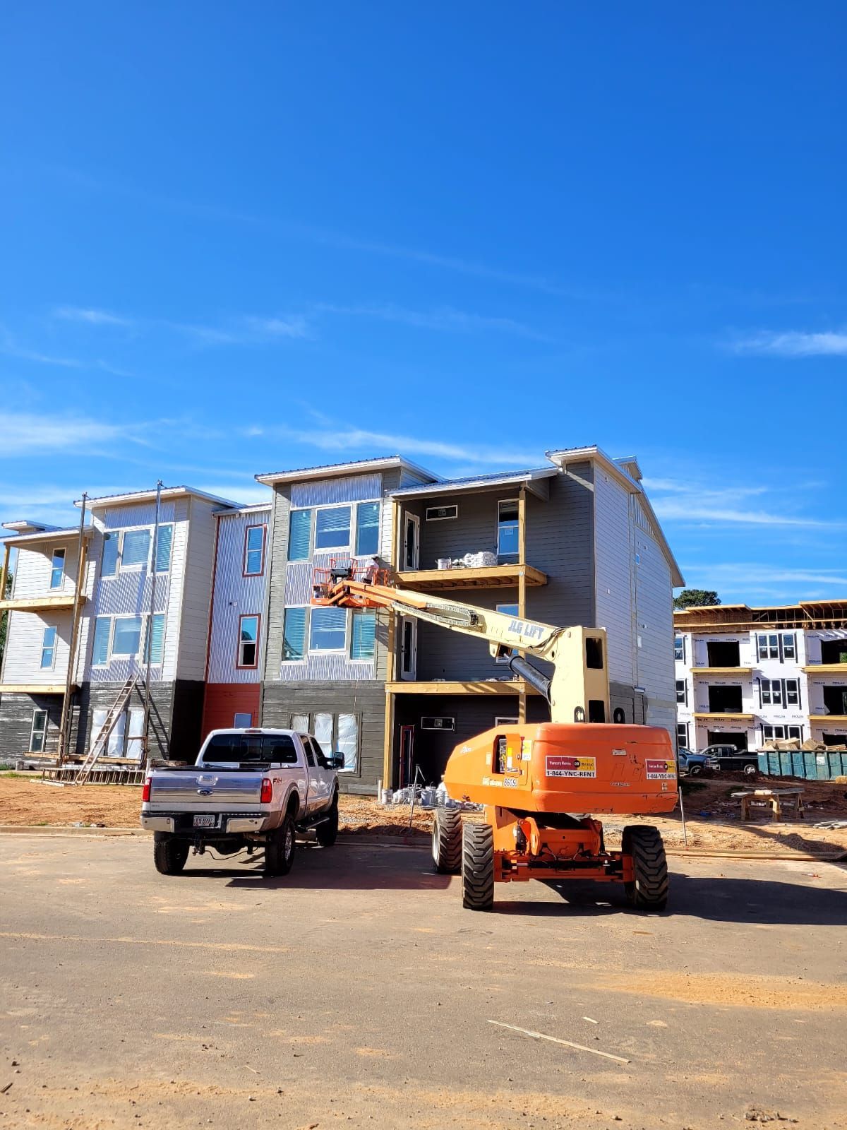A truck is parked in front of a building under construction