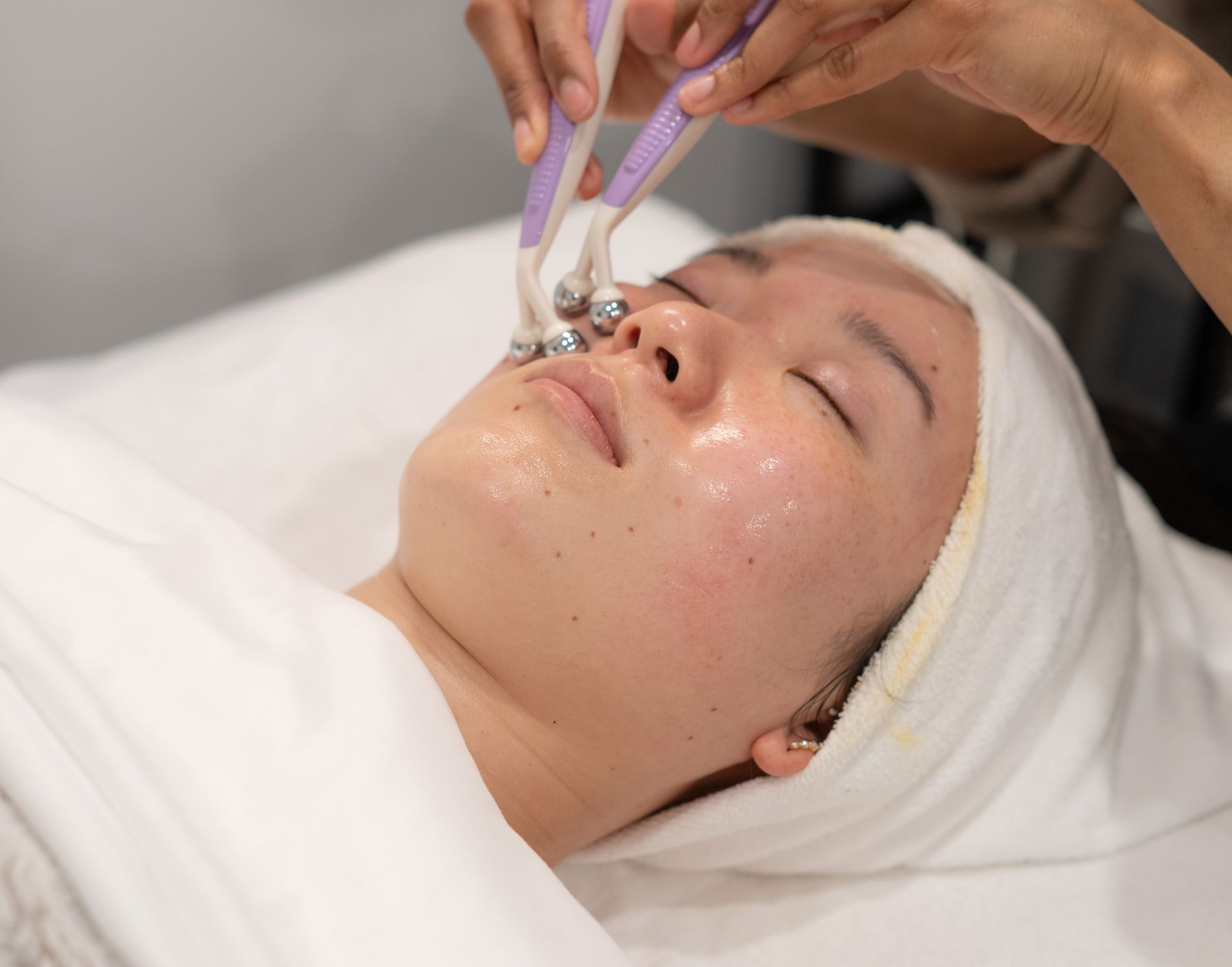 A woman is getting a facial treatment at a spa.
