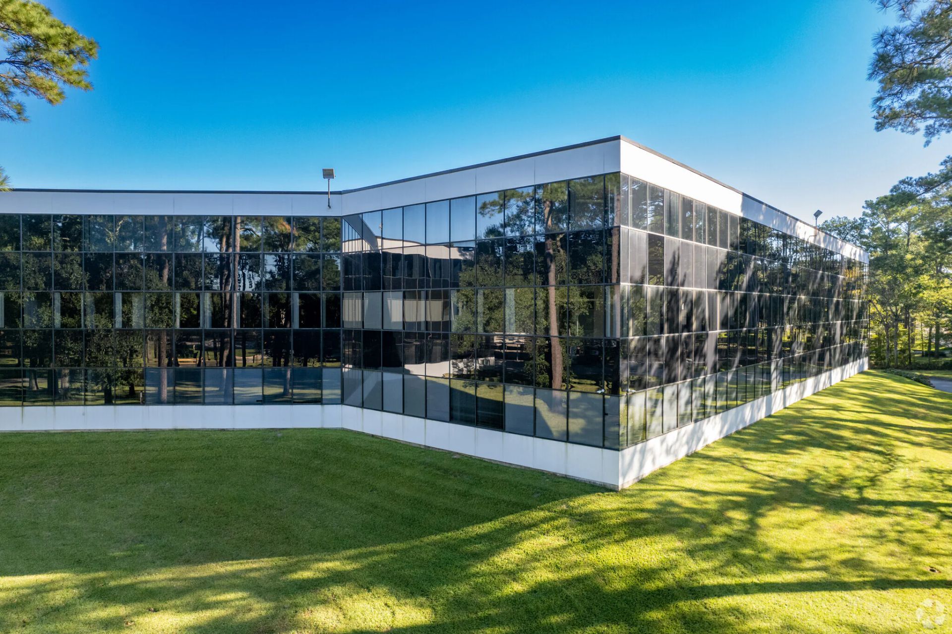 Indoor atrium with plants in planters and a staircase.