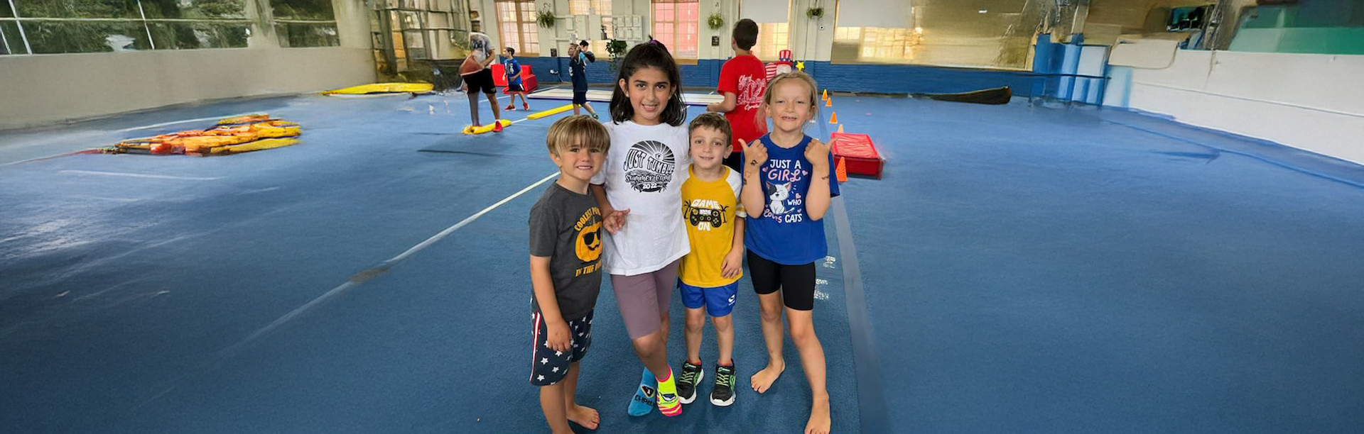 A boy is pointing at a sign that says summer camp