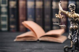 Attorney — Justice Scale With Books In Background in El Paso, TX