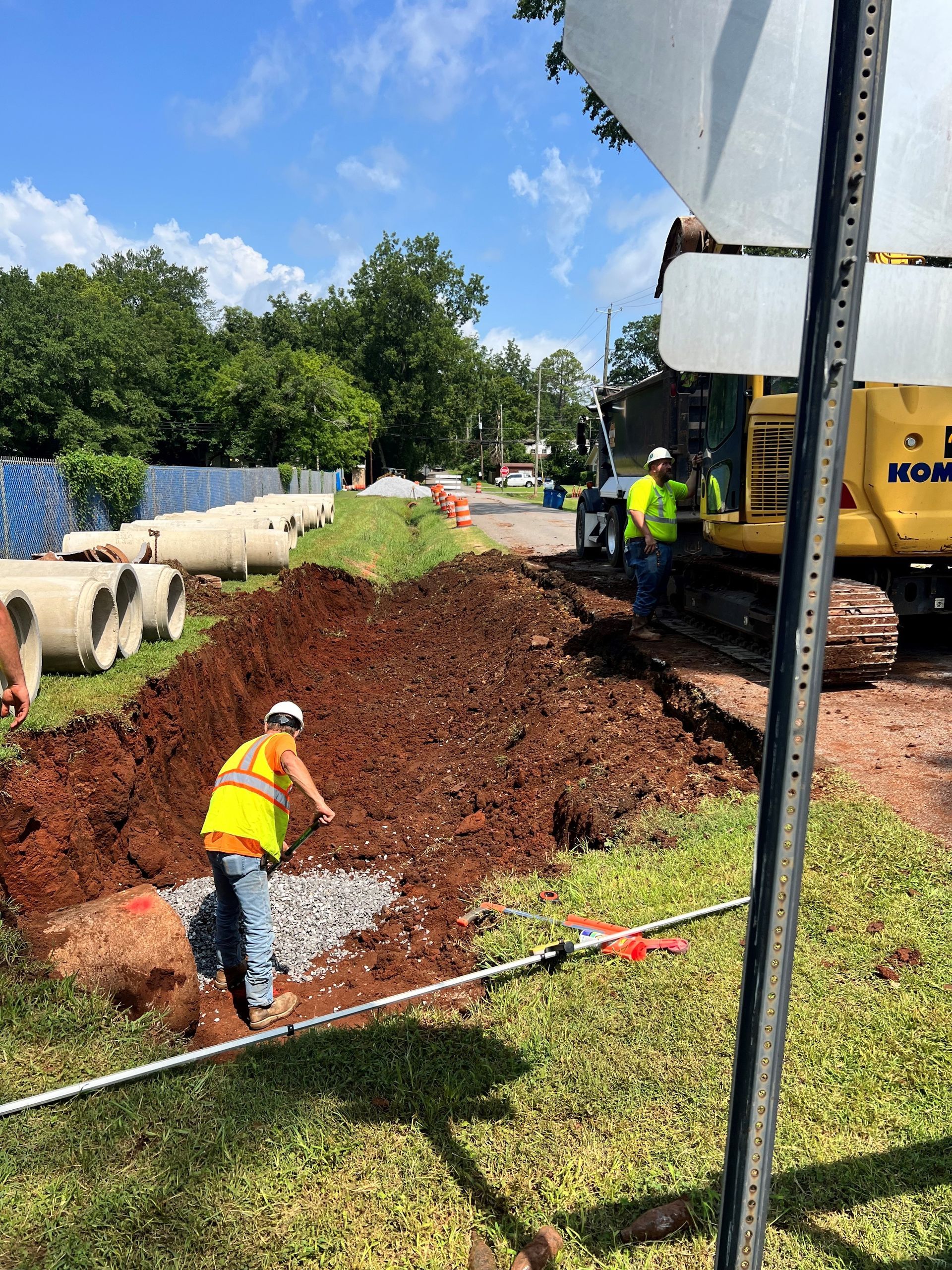 A group of construction workers are working on a road.