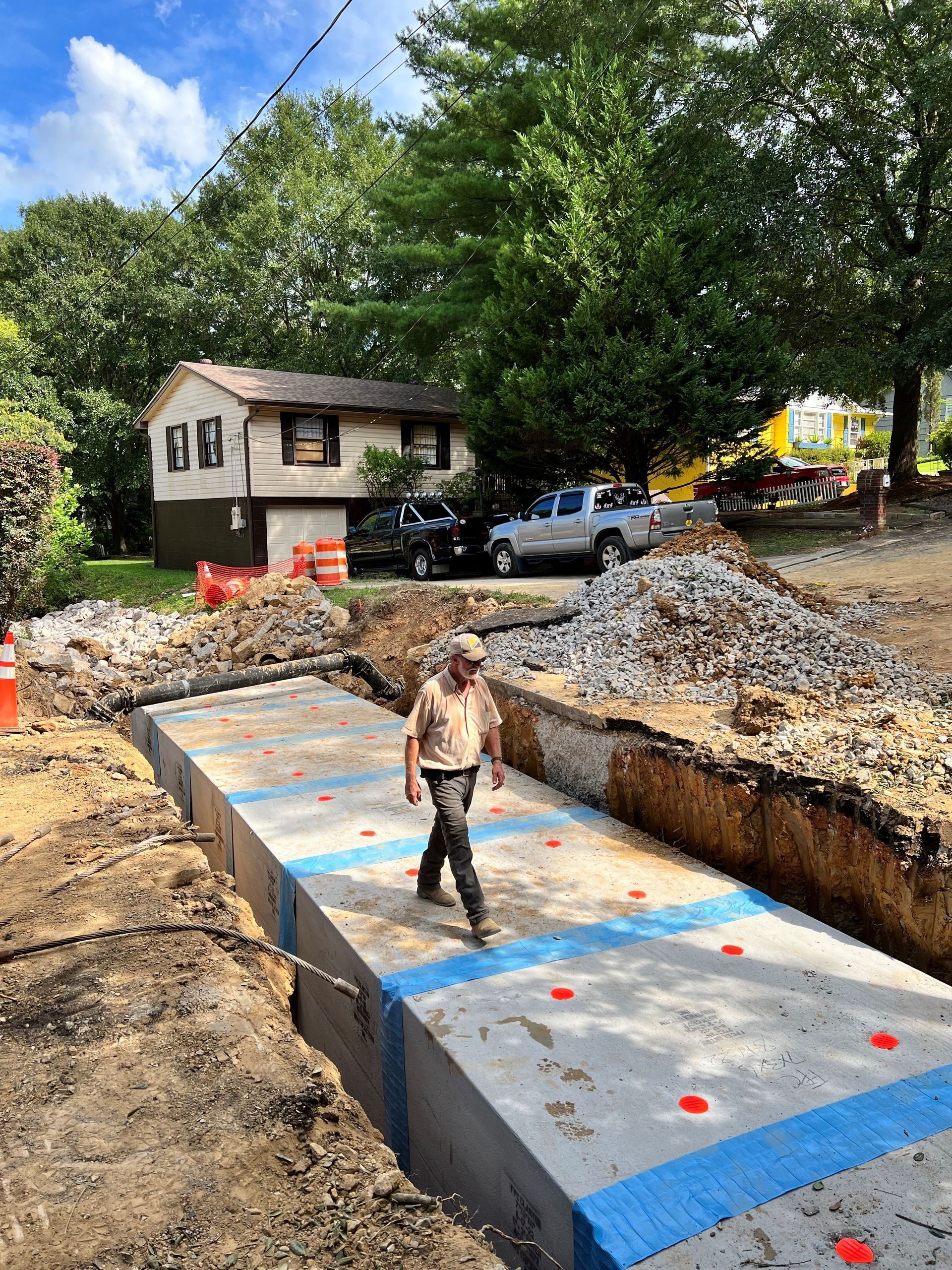 A man is walking across a large concrete slab in a construction site.
