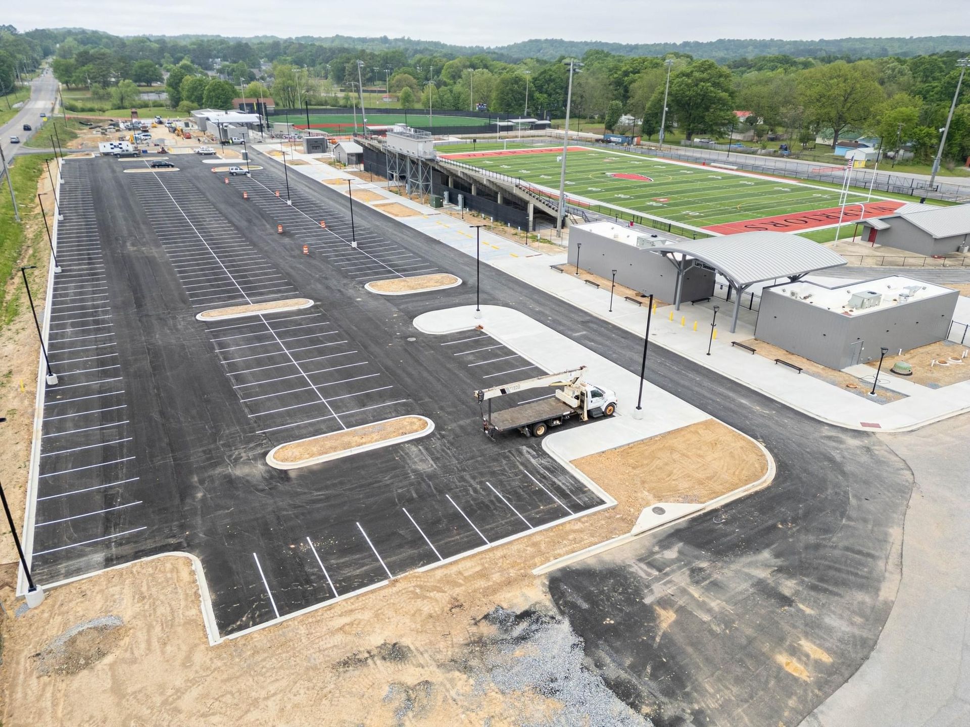 A concrete curb is being installed on the side of a road.