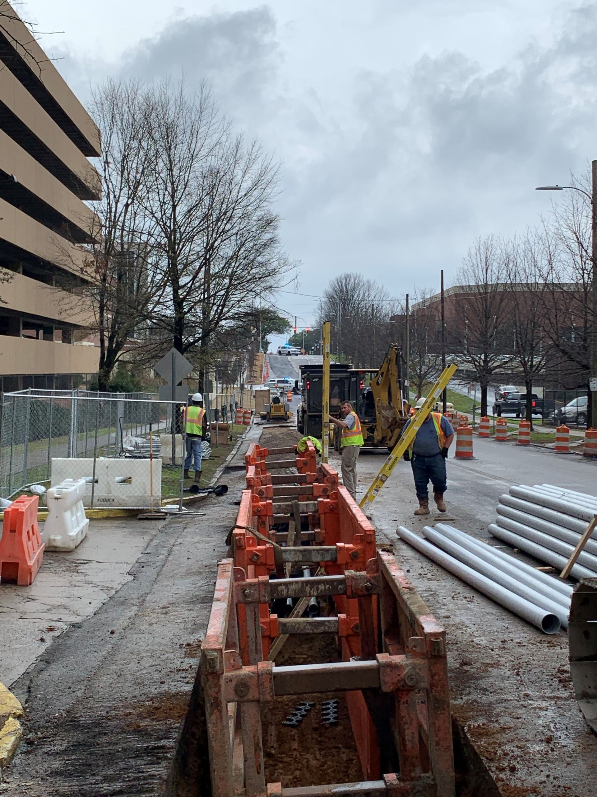 A group of construction workers are working on a road.