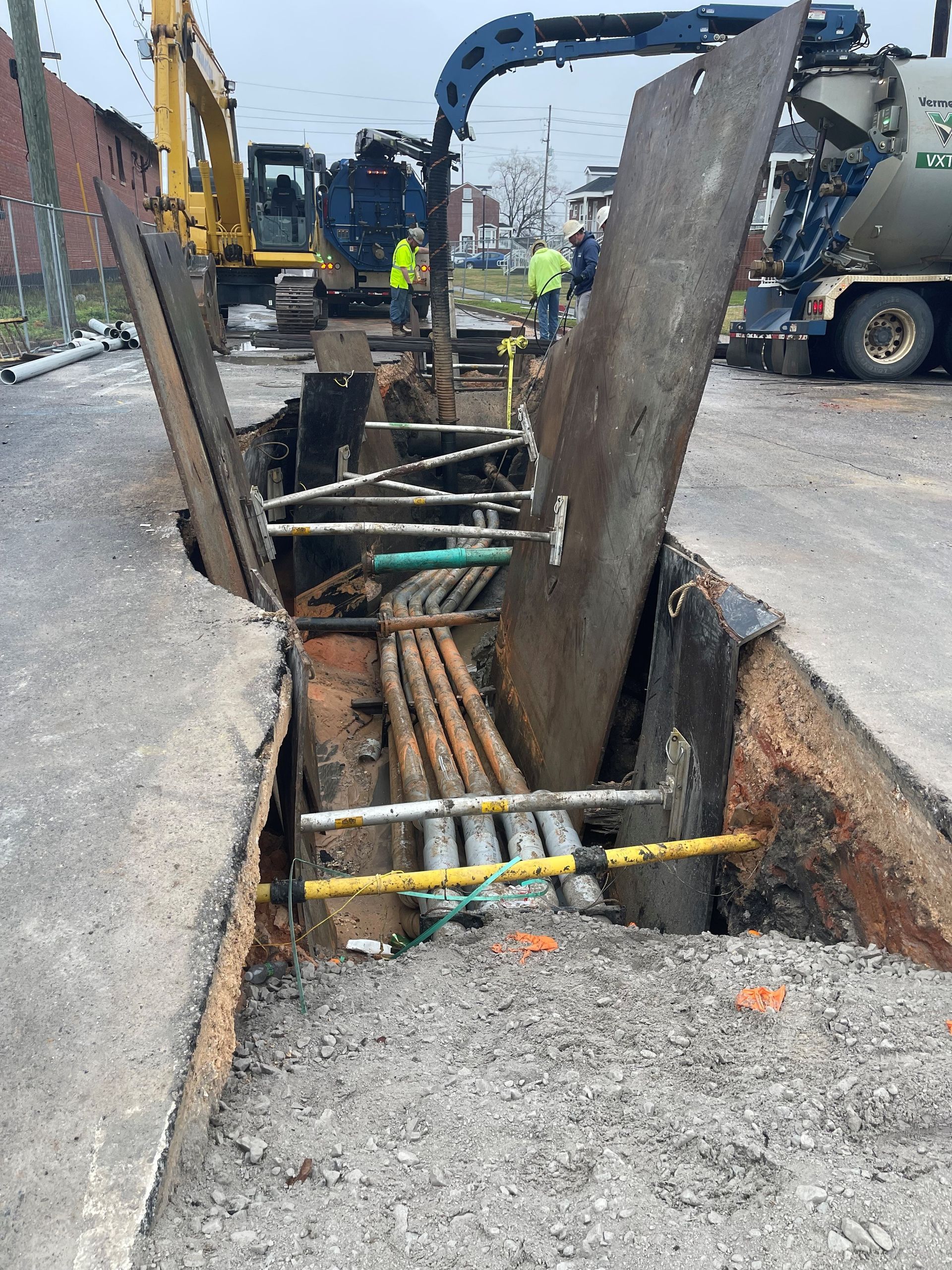 A large hole in the ground with a bunch of pipes in it