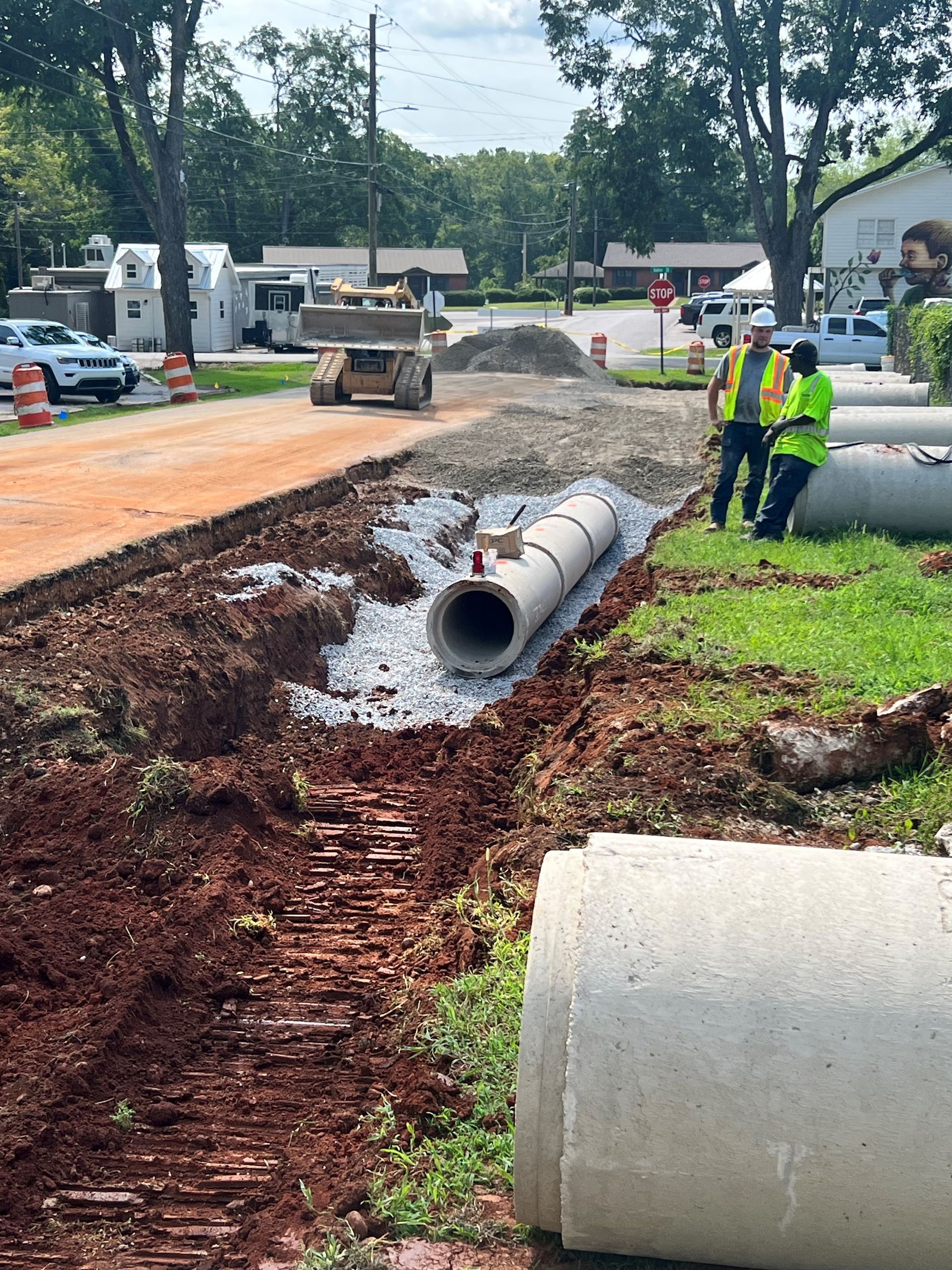 A group of construction workers are working on a road.