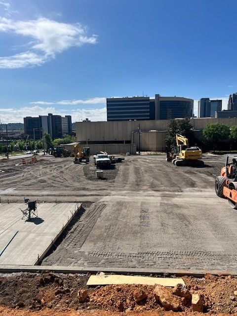 A construction site with a large building in the background