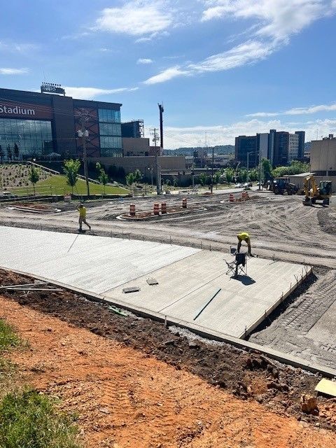 A construction site with a large building in the background