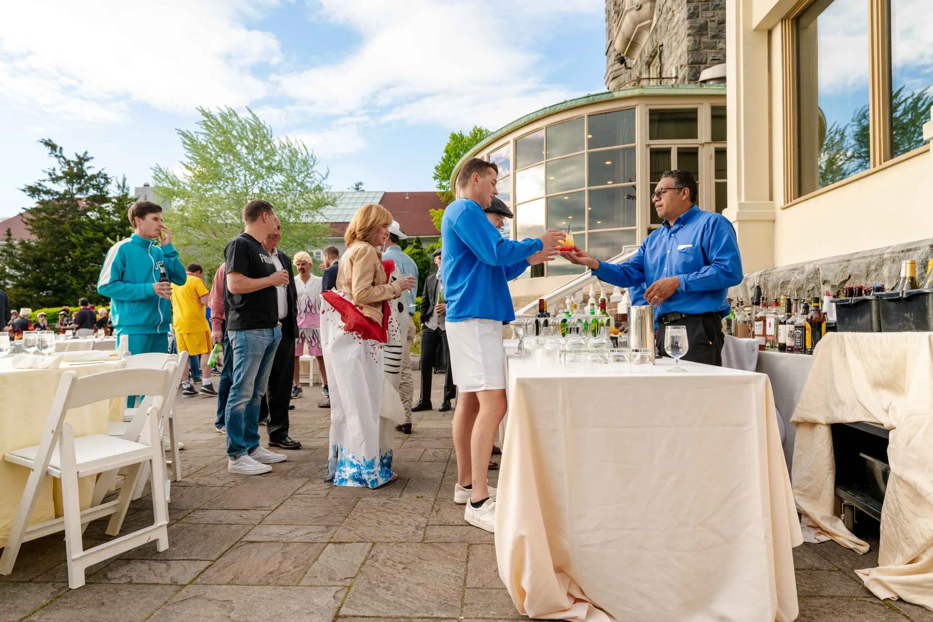A group of people are standing around a table at a party.