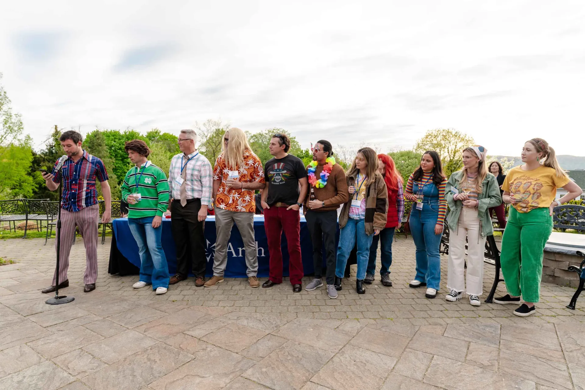 A group of people are standing next to each other on a sidewalk.