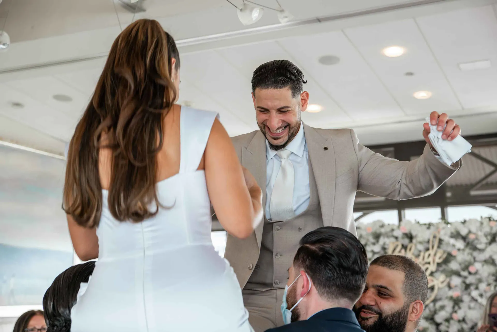 A bride and groom are dancing at their wedding reception.
